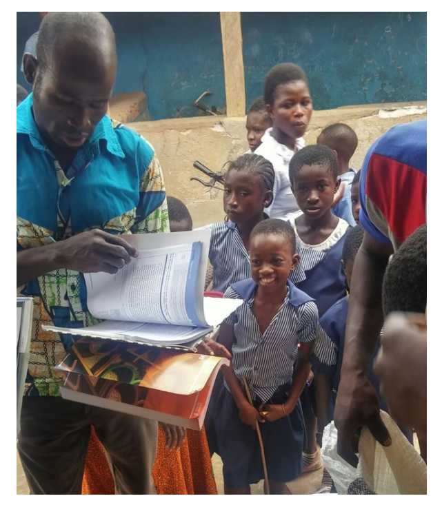 Schoolchildren receiving books and learning materials
