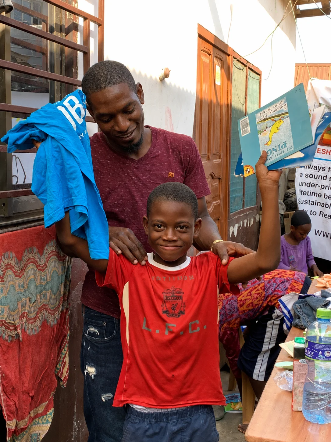 A young learner holding a book during a community activity