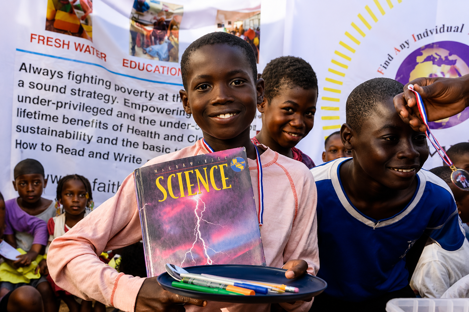 Children receiving education supplies through F.A.I.T.H. Worldwide Organization
