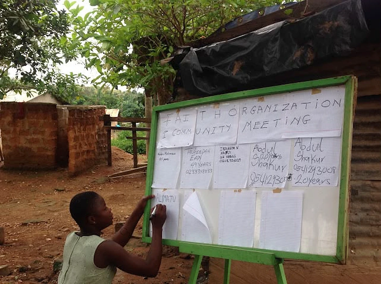A participant writing during a F.A.I.T.H. community literacy activity